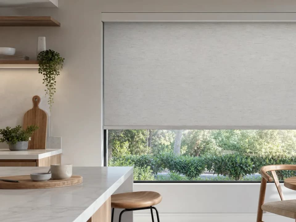 Flat roller shade fabric rolled part-way on a modern window