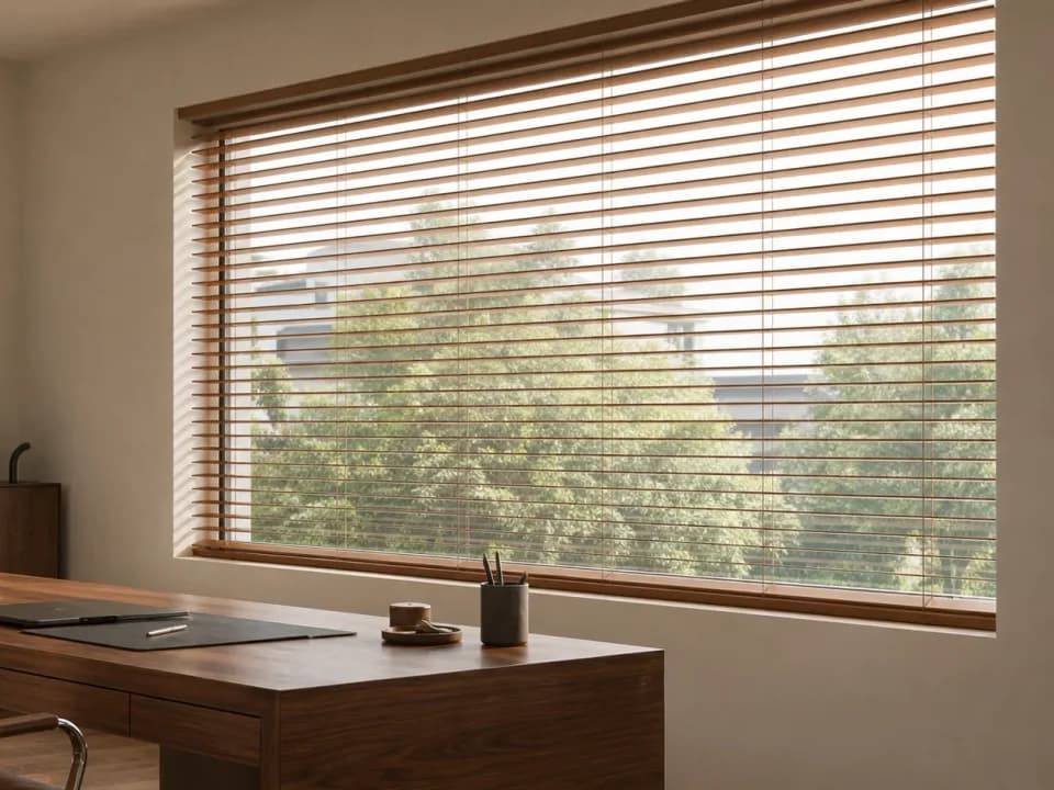 Warm-toned Venetian blind slats tilted to redirect daylight
